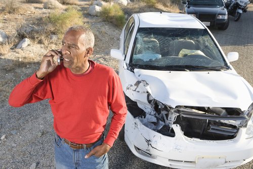 Person on phone after car accident