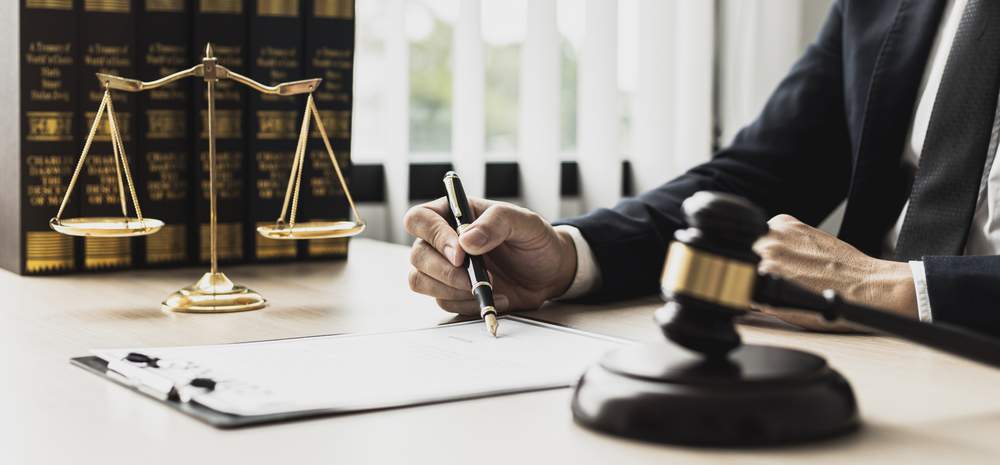 a male lawyer filing a camp lejeune lawsuit at his desk