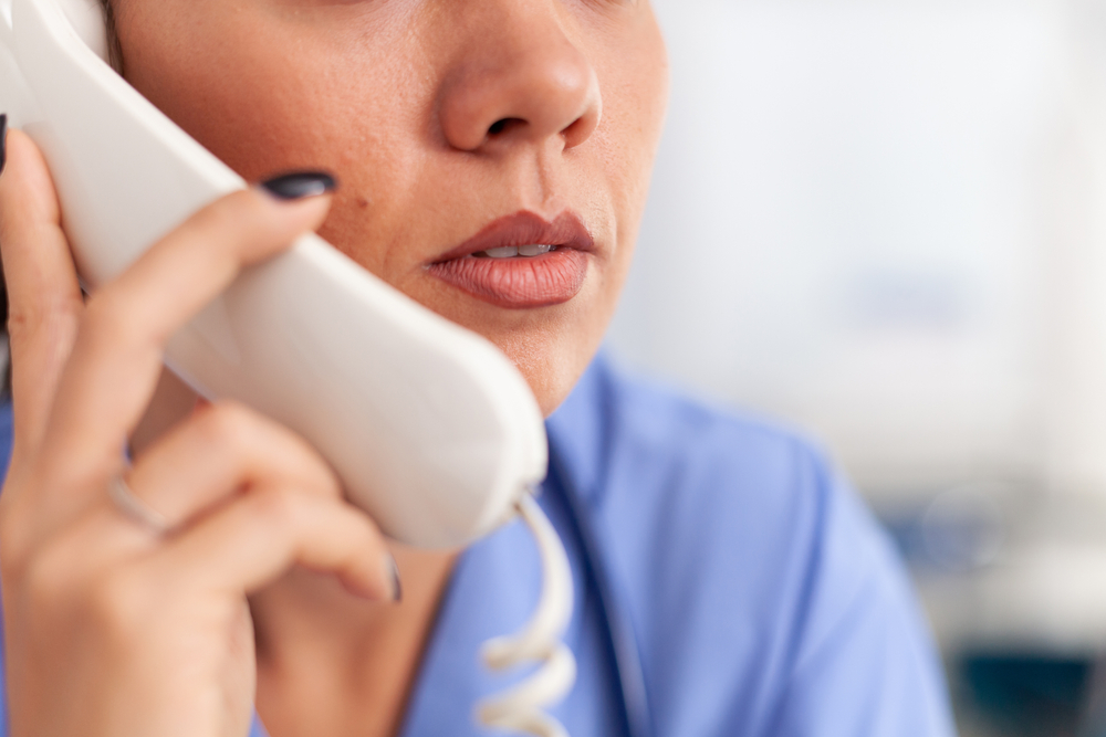 closeup of a female nurse on the phone